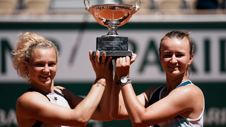 Czech Republic's Barbora Krejcikova, right, and compatriot Katerina Siniakova hold the cup after defeating USA's Bethanie Mattek-Sands and Poland's Iga Swiatek in their women's doubles final match of the French Open tennis tournament at the Roland Garros stadium Sunday, June 13, 2021 in Paris. (AP Photo/Thibault Camus)