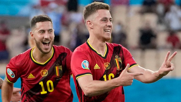 Belgium's Eden Hazard and Thorgan Hazard celebrate after Thorgan scored his side's first goal during the Euro 2020 soccer championship round of 16 match between Belgium and Portugal at the La Cartuja stadium in Seville