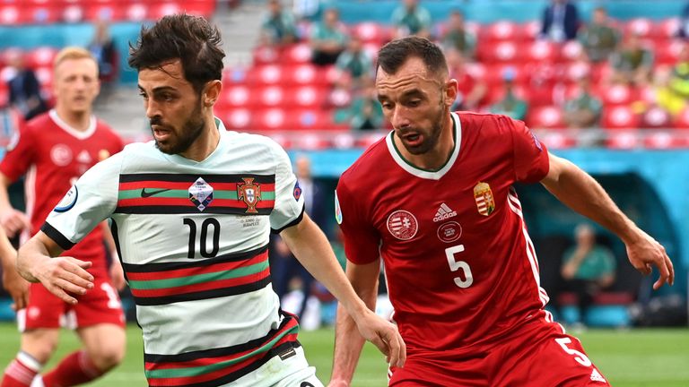 Portugal's Bernardo Silva challenges for the ball with Hungary's Attila Fiola
