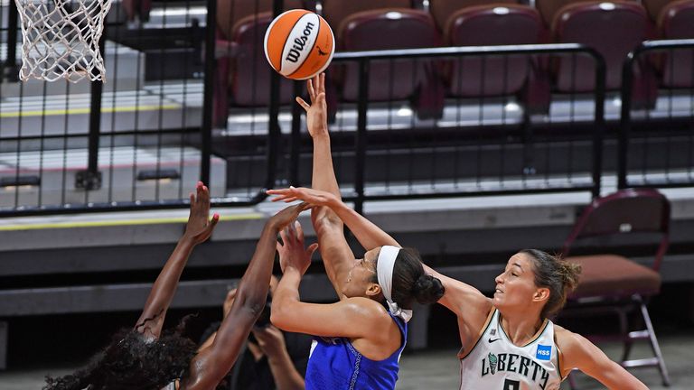 Connecticut Sun forward Brionna Jones is fouled on her shot as New York Liberty forward Michaela Onyenwere and Rebecca Allen defend during a WNBA basketball game