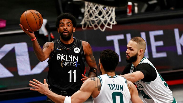 Brooklyn Nets guard Kyrie Irving (11) drives to the basket past Boston Celtics forward Jayson Tatum in the second half of Game 5 during an NBA basketball first-round playoff series, Tuesday, June 1, 2021, in New York. (AP Photo/Adam Hunger)
