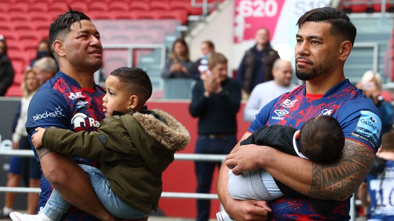 Charles Piutau (r) and Siale Piutau of Bristol Bears look dejected as they hold their sons 