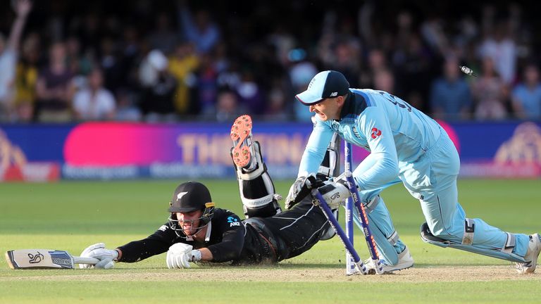 Jos Buttler runs out Martin Guptill during the Super Over in the Cricket World Cup final between England and New Zealand at Lord's