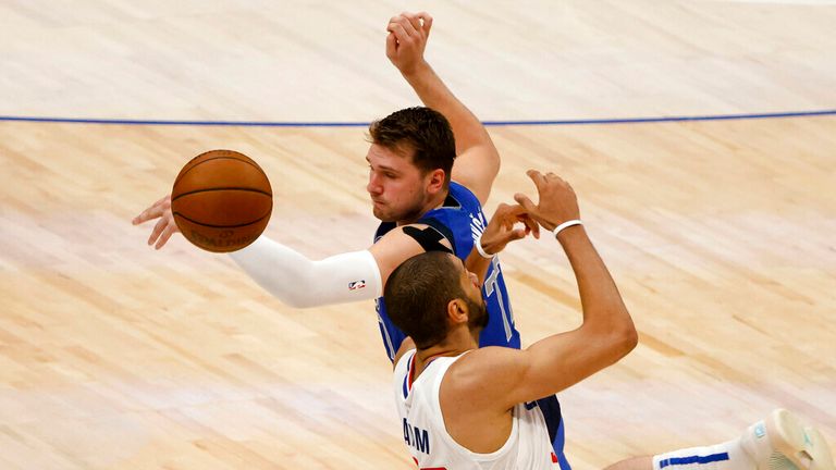 Dallas Mavericks guard Luka Doncic, top, breaks up a pass intended for Los Angeles Clippers forward Nicolas Batum, bottom, in the second half during Game 6 of an NBA basketball first-round playoff series in Dallas, Friday, June 4, 2021. (AP Photo/Michael Ainsworth