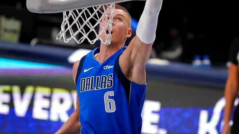 Dallas Mavericks center Kristaps Porzingis dunks the ball during the second half of an NBA basketball game against the San Antonio Spurs in Dallas, Sunday, April 11, 2021. (AP Photo/Tony Gutierrez)