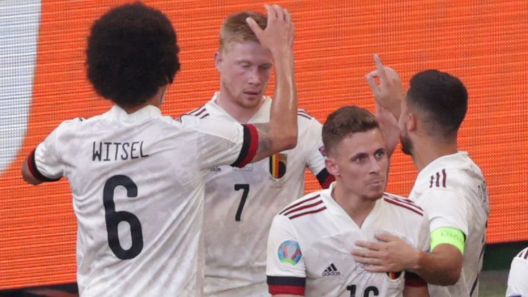 Belgium's Kevin De Bruyne, second left, celebrates after scoring his side's second goal during the Euro 2020 soccer championship group B match between Denmark and Belgium at the Parken stadium in Copenhagen, Denmark, Thursday, June 17, 2021. (Hannah McKay/Pool via AP)