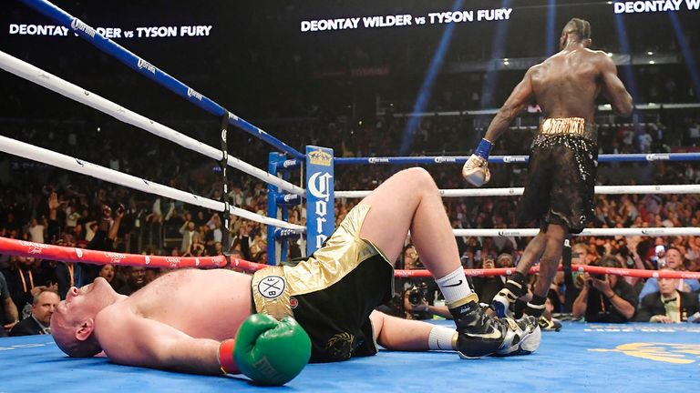 Tyson Fury, of England, lies on the canvas after being knocked down by Deontay Wilder during the 12th round of a WBC heavyweight championship boxing match Saturday, Dec. 1, 2018, in Los Angeles. (AP Photo/Mark J. Terrill)