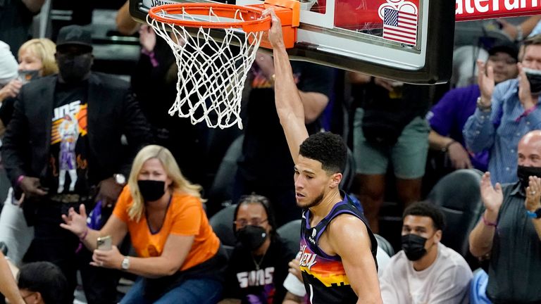 Phoenix Suns guard Devin Booker dunks against the Denver Nuggets during the first half of Game 2 of an NBA basketball second-round playoff series