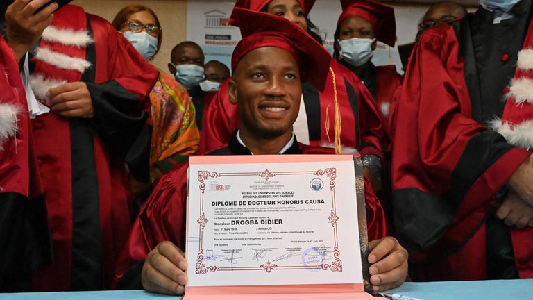 Ivorian former football star Didier Drogba (C) poses for a photograph after receiving an Honorary degree from the University of Sciences and Technology of Africa network (RUSTA) in Abidjan on June 3, 2021. (Photo by Issouf SANOGO / AFP) (Photo by ISSOUF SANOGO/AFP via Getty Images)