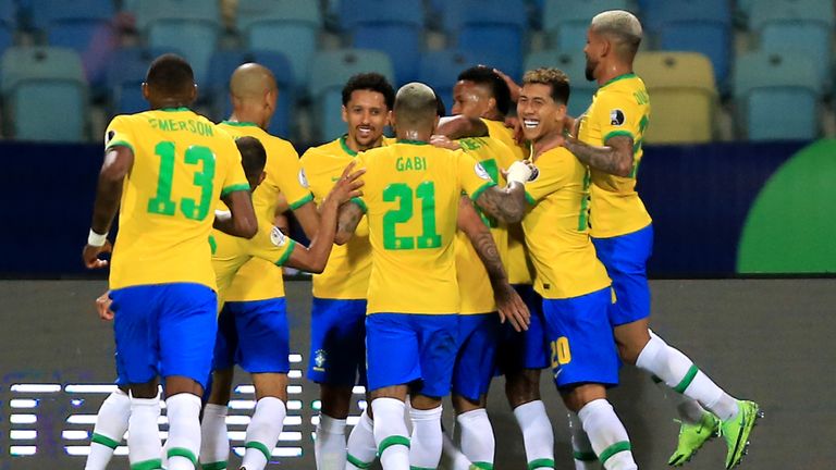 Eder Militao of Brazil celebrates with his team mates after scoring