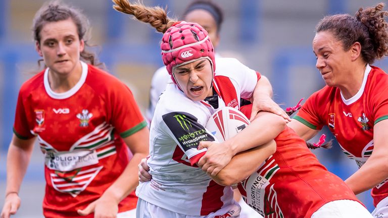England's Emily Rudge fights through the Welsh tackles.