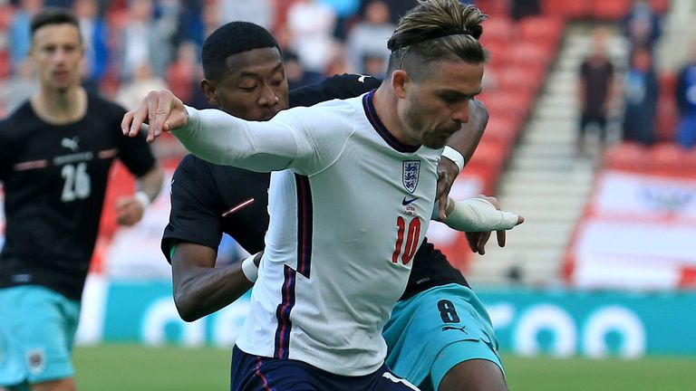England's Jack Grealish holds off Austria's David Alaba during the international friendly soccer match between England and Austria at the Riverside stadium in Middlesbrough, England, Wednesday June 2, 2021. (Lindsey Parnaby, Pool via AP)