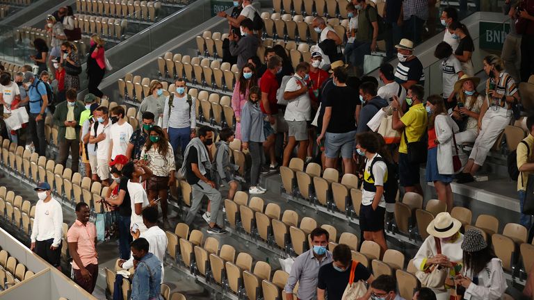 Play is suspended with fans being made to leave the stadium due to government curfew restrictions during the Mens Singles Quarter-Final match between Novak Djokovic and Matteo Berrettini 