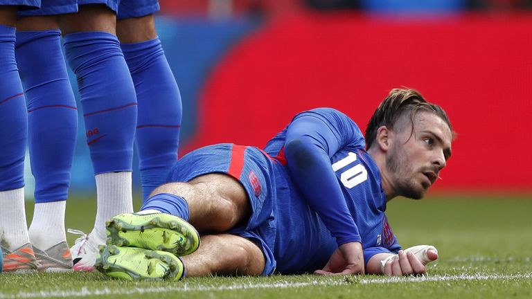 Jack Grealish lays down behind the England wall against Romania