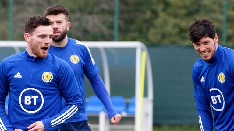 Scott McKenna (right) is backed to start alongside Grant Hanley and Andy Robertson