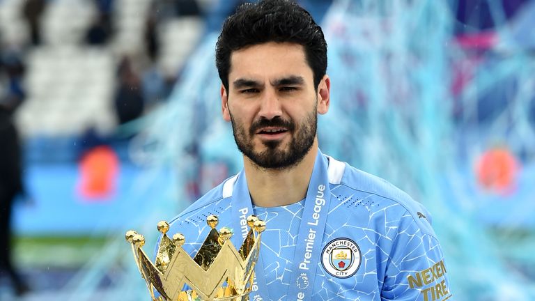 Manchester City's Ilkay Gundogan celebrates with the trophy after the final whistle in the Premier League match at the Etihad Stadium, Manchester. Picture date: Sunday May 23, 2021.