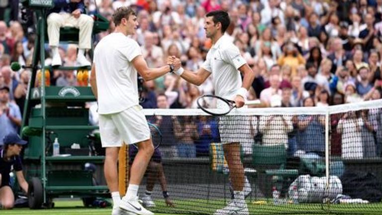 Jack Draper (left) shakes hands with Novak Djokovic after their match on Centre Court on day one of Wimbledon at The All England Lawn Tennis and Croquet Club, Wimbledon. Picture date: Monday June 28, 2021.