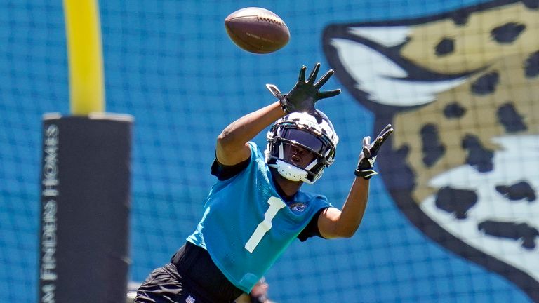 Jacksonville Jaguars running back Travis Etienne Jr. (1) catches a pass during a drill at NFL football rookie minicamp, Saturday, May 15, 2021, in Jacksonville, Fla.