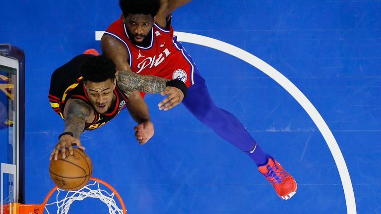 Atlanta Hawks&#39; John Collins goes up for a dunk past Philadelphia 76ers&#39; Joel Embiid during Game 1 of a second-round NBA basketball playoff series