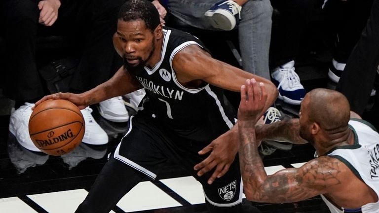 Brooklyn Nets' Kevin Durant, left, drives past Milwaukee Bucks' P.J. Tucker during the first half of Game 7 of a second-round NBA basketball playoff series Saturday, June 19, 2021, in New York. (AP Photo/Frank Franklin II)