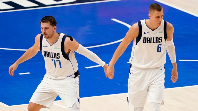 Dallas Mavericks&#39; Luka Doncic and Kristaps Porzingis celebrate an early basket by Porzingis in the first half in Game 4 of an NBA basketball first-round playoff series against the Los Angeles Clippers