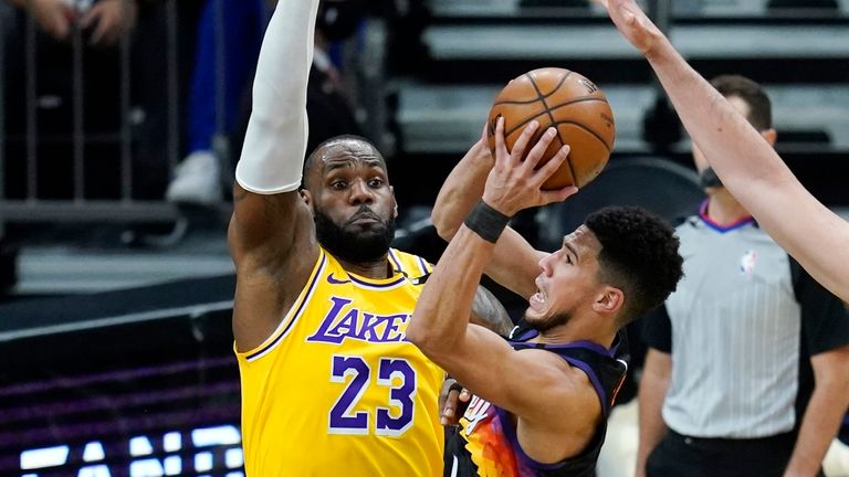 Phoenix Suns guard Devin Booker gets off a shot over Los Angeles Lakers forward LeBron James