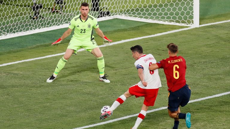 Poland's Robert Lewandowski sees a great chance saved against Spain