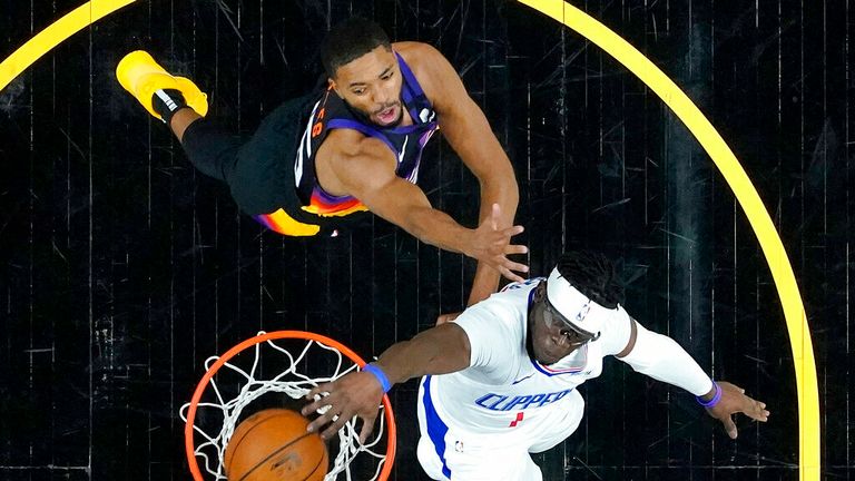 Los Angeles Clippers guard Reggie Jackson dunks as Phoenix Suns forward Mikal Bridges defends during the first half of game 5 of the NBA basketball Western Conference Finals, Monday, June 28, 2021, in Phoenix. (AP Photo/Matt York)