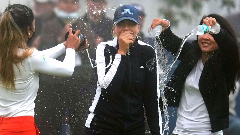 Matilda Castren, center, of Finland, reacts as she is doused with water and champagne after winning the LPGA Mediheal Championship golf tournament at the Lake Merced Golf Club Sunday, June 13, 2021, in Daly City, Calif. (AP Photo/Tony Avelar)