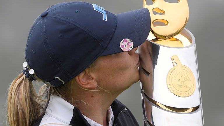 Matilda Castren, of Finland, kisses her trophy on 18th green of the Lake Merced Golf Club after winning the LPGA Mediheal Championship golf tournament  Sunday, June 13, 2021, in Daly City, Calif. (AP Photo/Tony Avelar)