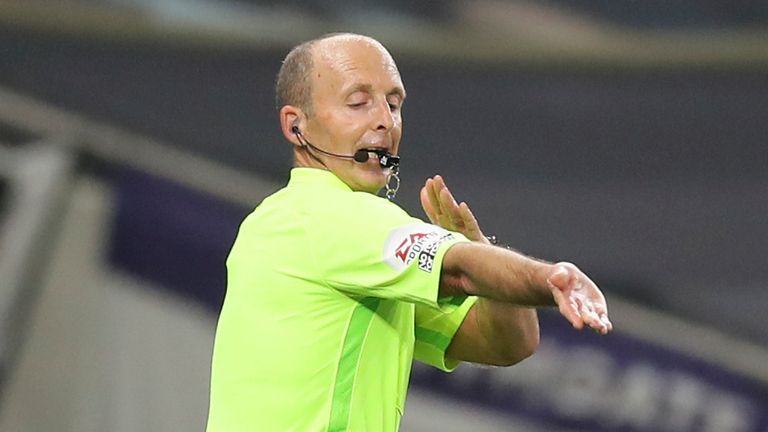 Mike Dean rules out a goal following a accidental handball in a Premier League fixture between Tottenham and Man City
