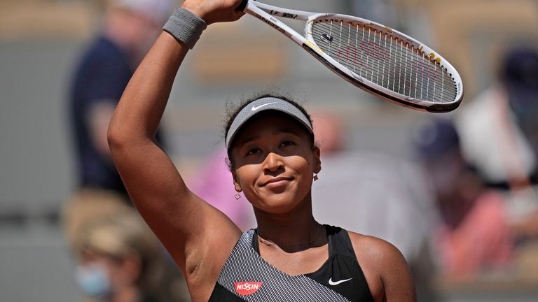Naomi Osaka celebrates after defeating Romania's Patricia Maria Tig during their first round match of the French open tennis tournament at the Roland Garros stadium Sunday, May 30, 2021 in Paris. (AP Photo/Christophe Ena)