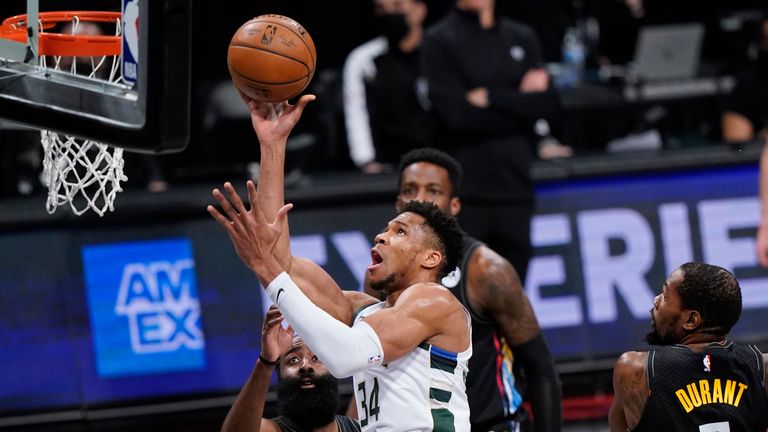 Milwaukee Bucks forward Giannis Antetokounmpo (34) shoots with Brooklyn Nets guard James Harden, left, and forward Kevin Durant (7) defending during the first half of Game 5 of a second-round NBA basketball playoff series Tuesday, June 15, 2021, in New York.