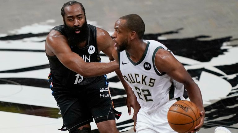 Brooklyn Nets guard James Harden (13) defends Milwaukee Bucks forward Khris Middleton (22) as Middleton drives to the basket during the first half of Game 5 of a second-round NBA basketball playoff series, Tuesday, June 15, 2021, in New York. 
