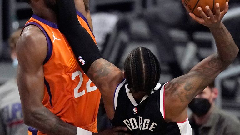 Los Angeles Clippers guard Paul George, right, hits Phoenix Suns center Deandre Ayton in the face as he tries to shoot during the first half in Game 3 of the NBA basketball Western Conference Finals Thursday, June 24, 2021, in Los Angeles. (AP Photo/Mark J. Terrill)


