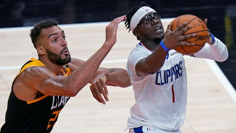 Los Angeles Clippers guard Reggie Jackson (1) goes to the basket as Utah Jazz center Rudy Gobert defends during the first half of Game 5 of a second-round NBA basketball playoff series Wednesday, June 16, 2021, in Salt Lake City.