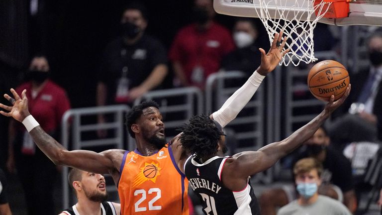 Los Angeles Clippers guard Patrick Beverley, right, shoots as Phoenix Suns center Deandre Ayton defends during the first half in Game 3 of the NBA basketball Western Conference Finals Thursday, June 24, 2021, in Los Angeles. (AP Photo/Mark J. Terrill)


