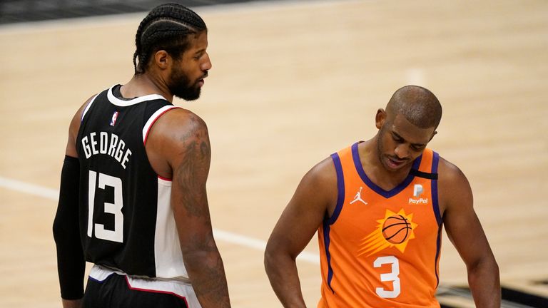 Los Angeles Clippers guard Paul George, left, tires to talk to Phoenix Suns guard Chris Paul during the second half in Game 3 of the NBA basketball Western Conference Finals Thursday, June 24, 2021, in Los Angeles. (AP Photo/Mark J. Terrill) 