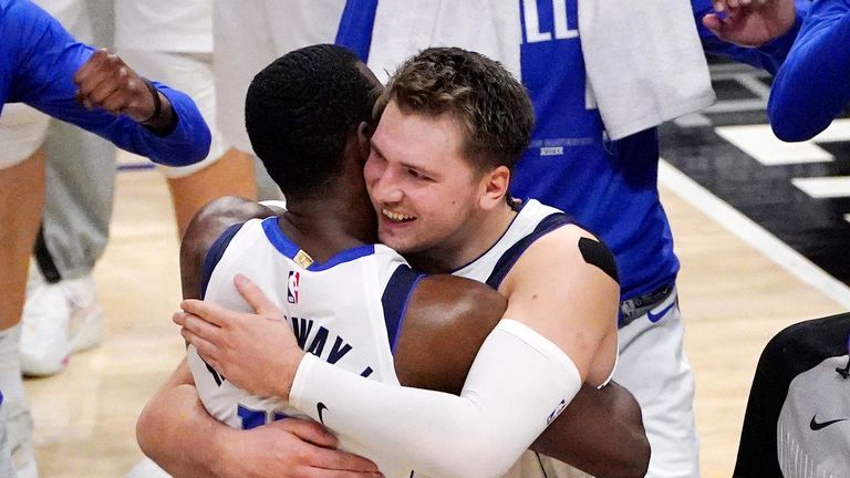 Dallas Mavericks guard Luka Doncic, center right, hugs forward Tim Hardaway Jr. after the Mavericks defeated the Los Angeles Clippers 105-100 in Game 5 of an NBA basketball first-round playoff series Wednesday, June 2, 2021, in Los Angeles.