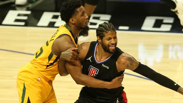 Donovan Mitchell and Paul George tussle for the ball during Game 4