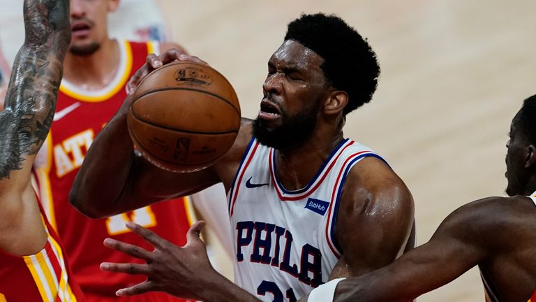 Philadelphia 76ers center Joel Embiid (21) is fouled by Atlanta Hawks forward Tony Snell (19), right, as Hawks forward John Collins (20) defends during the first half of Game 3 of a second-round NBA basketball playoff series, Friday, June 11, 2021, in Atlanta. 