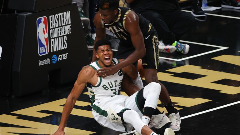 Giannis Antetokounmpo is injured after contesting a Clint Capela alley-oop and hyperextending his left knee upon landing