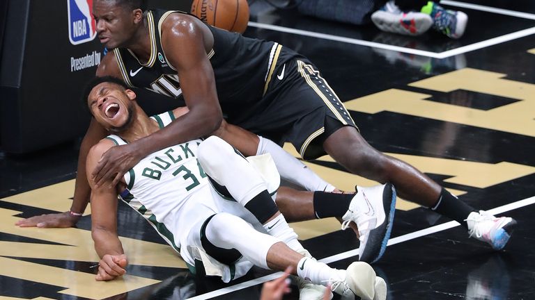 Atlanta Hawks center Clint Capela, top, and Milwaukee Bucks forward Giannis Antetokounmpo fall to the court during the third quarter in Game 4 of the Eastern Conference finals in the NBA basketball playoffs Tuesday, June 29, 2021, in Atlanta. Antetokounmpo left the game. 