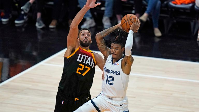 Utah Jazz center Rudy Gobert (27) guards Memphis Grizzlies guard Ja Morant (12) during the second half of Game 5 of an NBA basketball first-round playoff series Wednesday, June 2, 2021, in Salt Lake City.