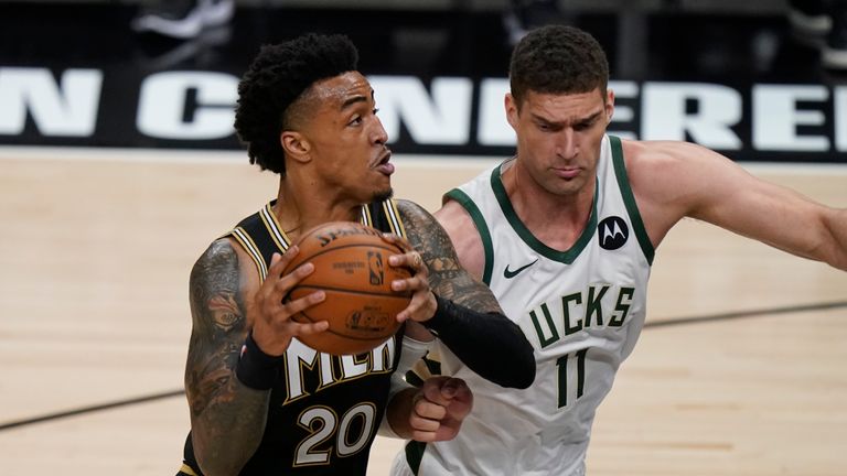 Atlanta Hawks&#39; John Collins (20) drives the ball to the basket against Milwaukee Bucks&#39; Brook Lopez (11) during the first half of Game 4 of the NBA basketball Eastern Conference finals Tuesday, June 29, 2021, in Atlanta. 