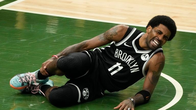 Brooklyn Nets&#39; Kyrie Irving holds his leg after being injured during the first half of Game 4 of the NBA Eastern Conference basketball semifinals game against the Milwaukee Bucks Sunday, June 13, 2021, in Milwaukee. 