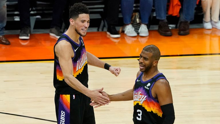 Phoenix Suns guard Devin Booker (1) and  guard Chris Paul celebrate during the first half of Game 5 of an NBA basketball first-round playoff series against the Los Angeles Lakers, Tuesday, June 1, 2021, in Phoenix. (AP Photo/Matt York)