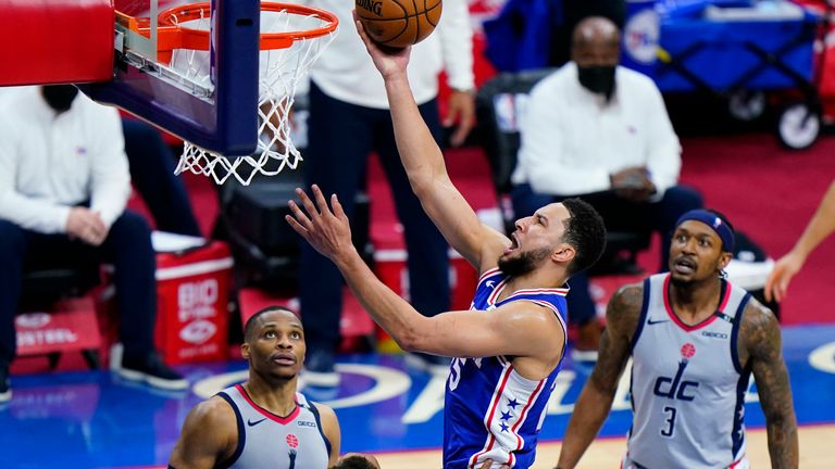 Philadelphia 76ers' Ben Simmons, center, goes up for a shot against Washington Wizards' Daniel Gafford, left, during the first half of Game 5 in a first-round NBA basketball playoff series, Wednesday, June 2, 2021, in Philadelphia.