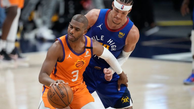 Phoenix Suns guard Chris Paul, front, protects the ball as Denver Nuggets forward Aaron Gordon defends in the second half of Game 3 of an NBA second-round playoff series Friday, June 11, 2021, in Denver. Phoenix won 116-102.