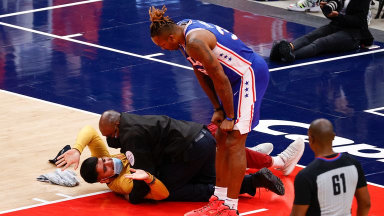 Philadelphia 76ers' center Dwight Howard looks down at a fan who ran onto the court and was tackled by security in Game Four of the Eastern Conference first round series against the Washington Wizards